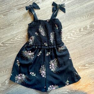 Zunie Girls Romper with Bows on the Shoulder. Black with flowers design.